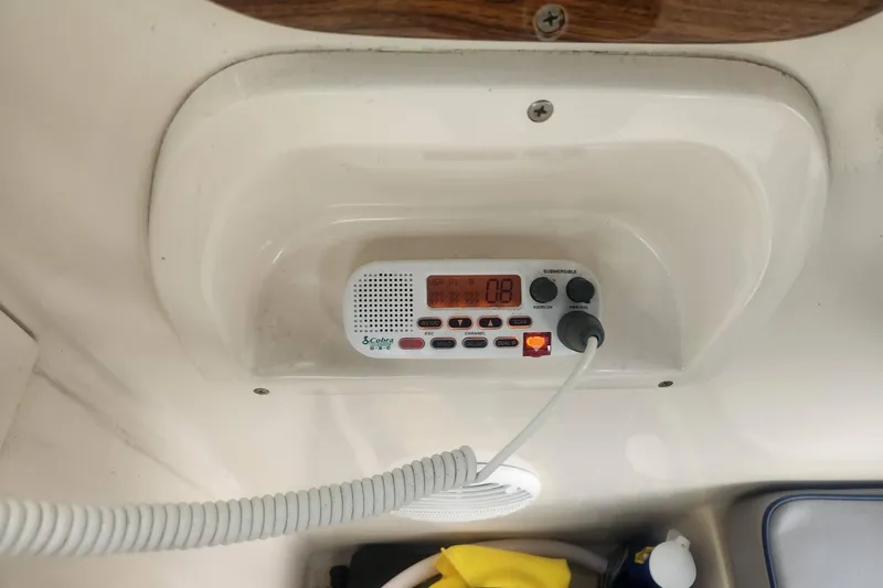 Slide: The Image of VHF radio installed on a 2003 Mainship Pilot 30-II boat dashboard. - 19