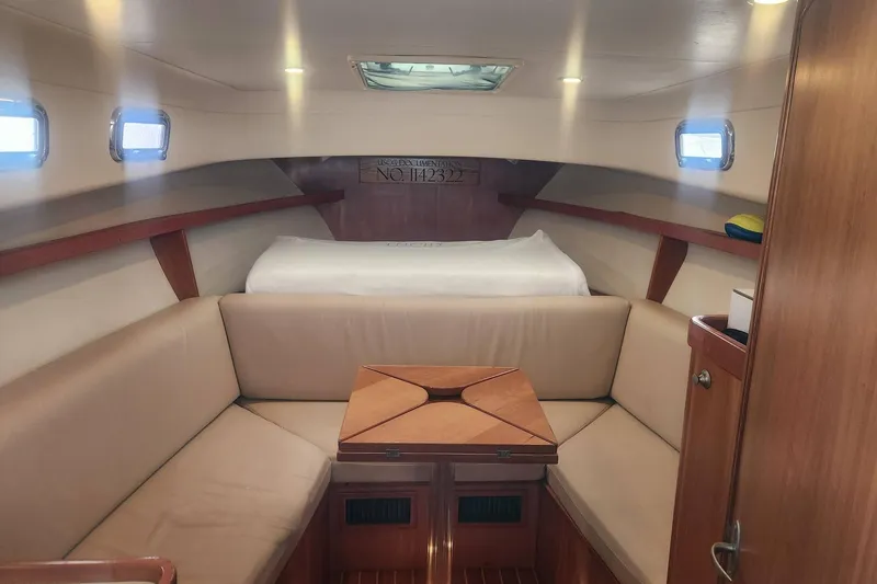 Slide: The Image of Cozy cabin interior of 2003 Mainship Pilot 30-II with beige seating and wooden accents. - 4