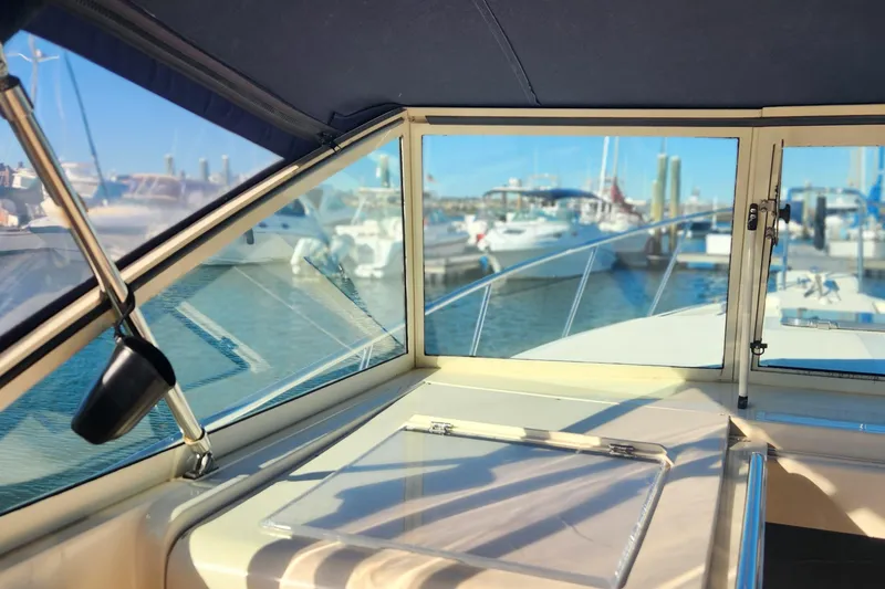 Slide: The Image of Interior view of 2003 Mainship Pilot 30-II boat at marina, showcasing windows and docked boats. - 5