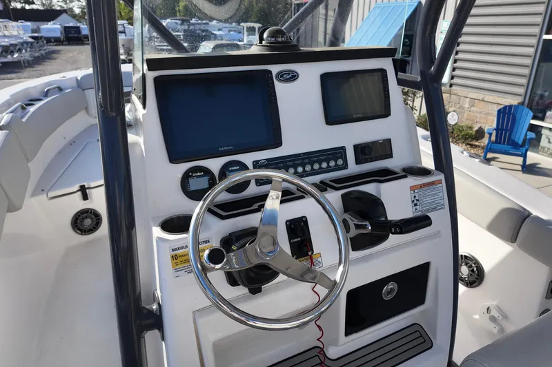 Slide: The Image of 2021 Sea Fox 248 Commander boat dashboard with steering wheel and navigation displays. - 11