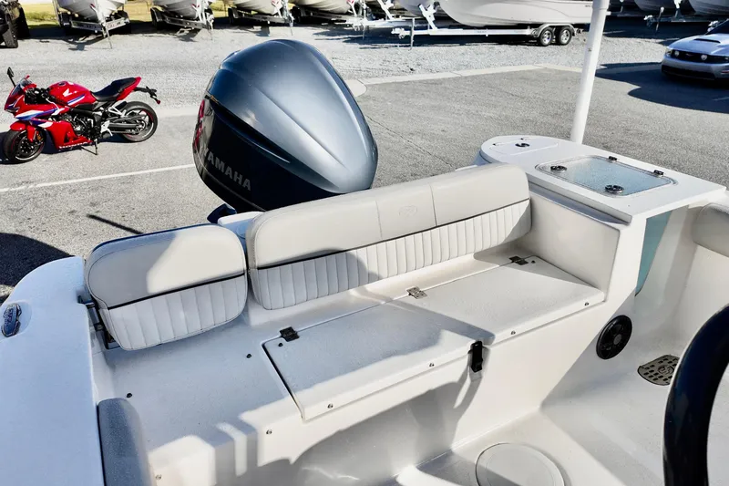 Slide: The Image of 2021 Sea Fox 248 Commander boat with Yamaha engine, parked near a red motorcycle. - 14