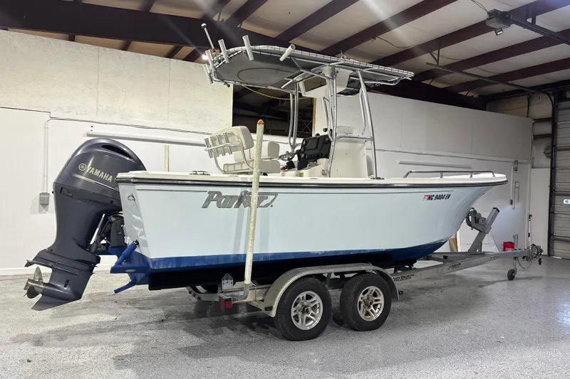 Slide: The Image of 2020 Parker 2100 Center Console boat on trailer in indoor storage. - 10
