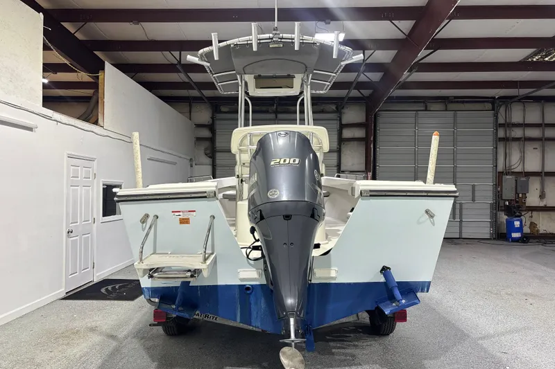Slide: The Image of 2020 Parker 2100 Center Console boat with Yamaha 200 engine in a warehouse. - 11