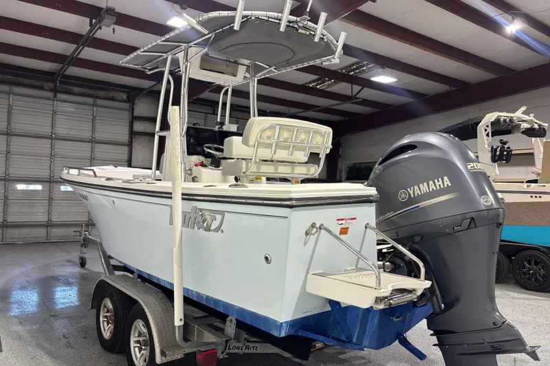 Slide: The Image of 2020 Parker 2100 Center Console boat with Yamaha engine in a garage. - 12