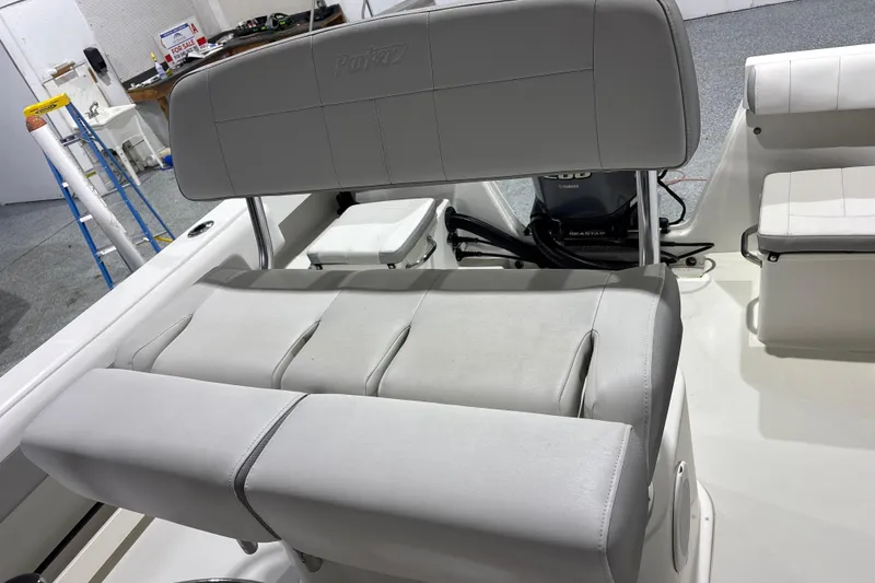 Slide: The Image of 2020 Parker 2100 Center Console boat interior with cushioned seating and Yamaha engine. - 16
