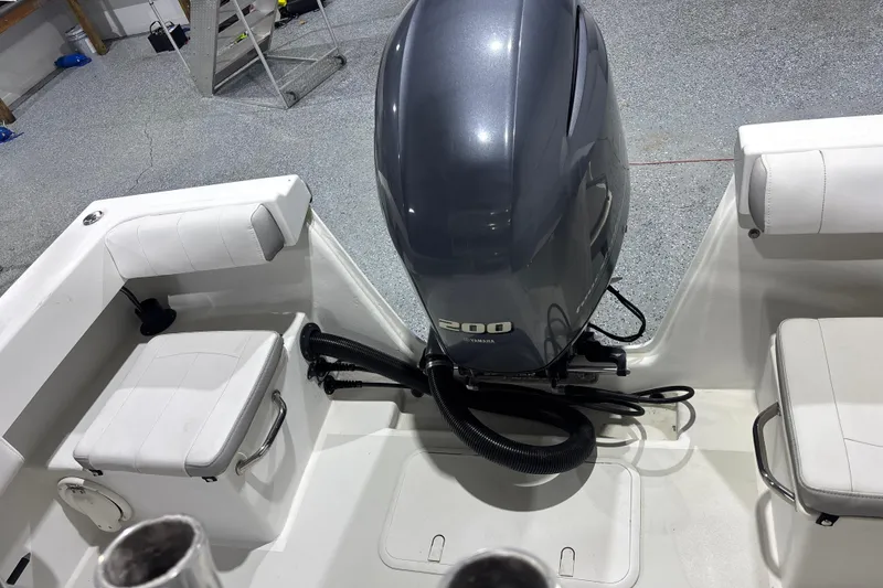 Slide: The Image of 2020 Parker 2100 Center Console boat with Yamaha 200 engine in a garage setting. - 17