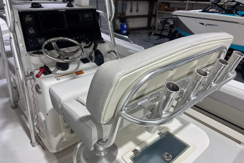 Slide: The Image of 2020 Parker 2100 Center Console boat interior with steering wheel and rod holders. - 18