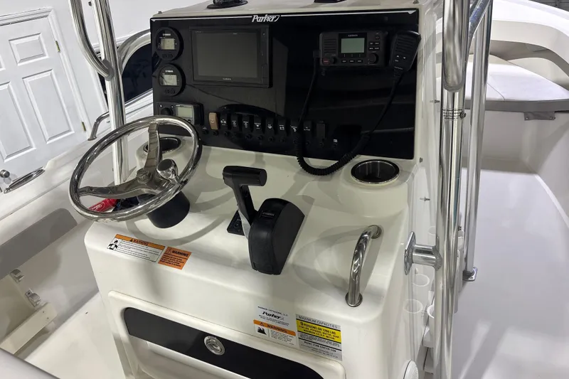 Slide: The Image of 2020 Parker 2100 Center Console boat dashboard with steering wheel and controls. - 20