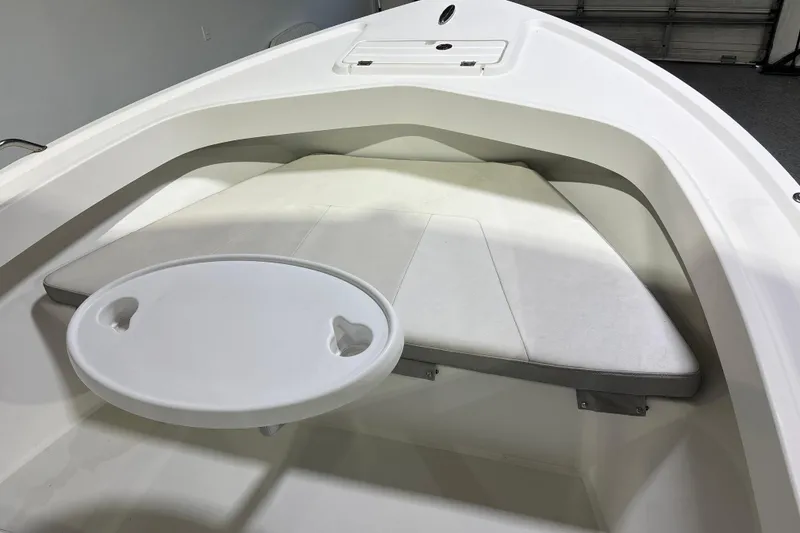 Slide: The Image of 2020 Parker 2100 Center Console boat interior with cushioned seating and round table. - 21