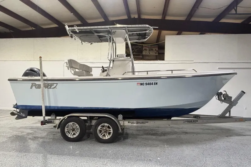 Slide: The Image of 2020 Parker 2100 Center Console boat on trailer in indoor storage. - 9