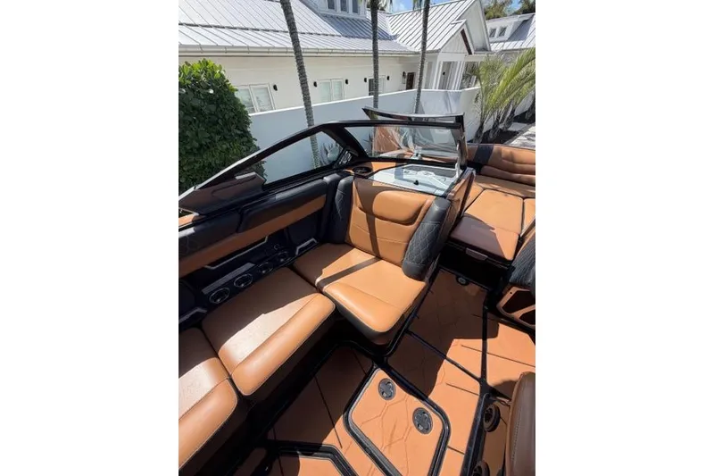 Slide: The Image of Luxurious interior of a 2021 Malibu M240 boat with tan leather seating. - 10