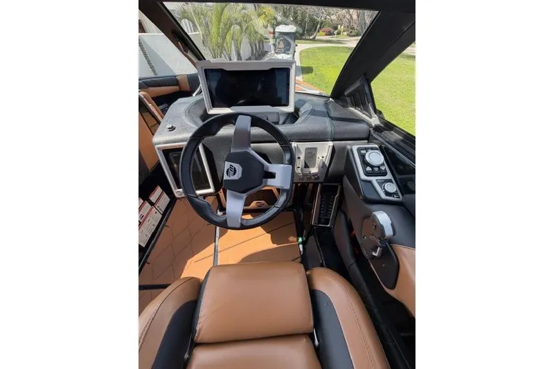 Slide: The Image of 2021 Malibu M240 boat interior with modern dashboard and steering wheel. - 9