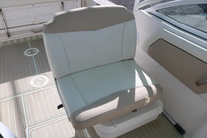 Slide: The Image of 2019 Robalo R247 Dual Console boat seat with beige and white upholstery. - 11