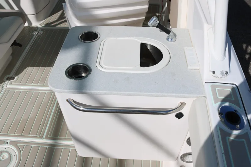 Slide: The Image of 2019 Robalo R247 Dual Console boat interior with sink and cup holders. - 13