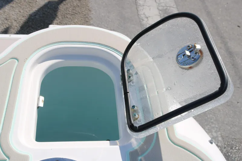 Slide: The Image of 2019 Robalo R247 Dual Console livewell with open lid, showcasing interior details. - 15