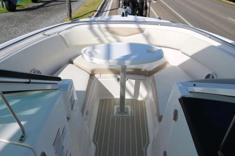 Slide: The Image of 2019 Robalo R247 Dual Console boat interior with seating and table. - 6