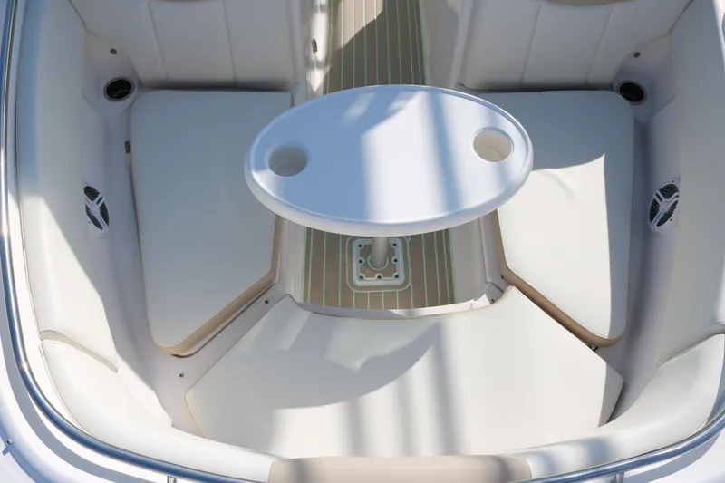 Slide: The Image of 2019 Robalo R247 Dual Console boat interior with seating and table. - 7