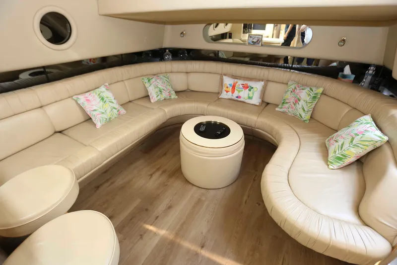 Slide: The Image of Luxurious interior of 1999 Sea Ray 500 Sundancer with curved seating and decorative pillows. - 10