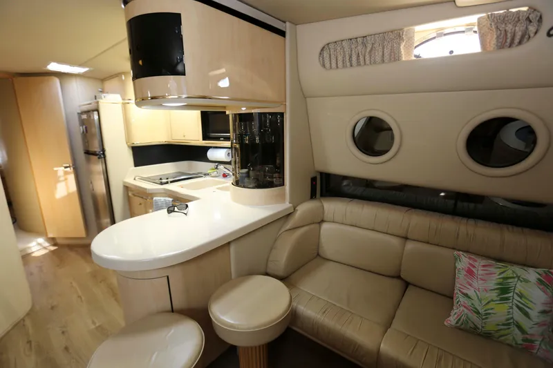 Slide: The Image of Luxurious interior of 1999 Sea Ray 500 Sundancer yacht with kitchen and seating area. - 11