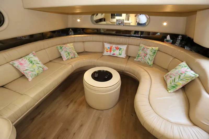 Slide: The Image of Luxurious 1999 Sea Ray 500 Sundancer interior with curved leather seating and decorative pillows. - 12