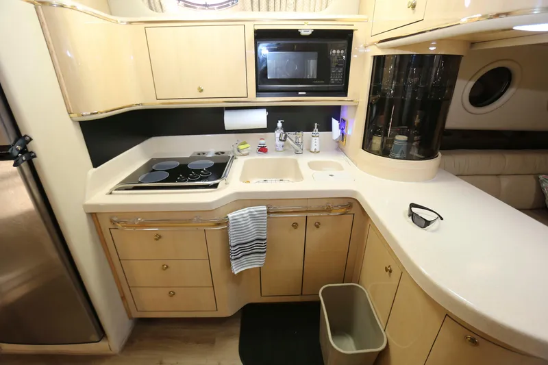 Slide: The Image of Luxurious kitchen interior of 1999 Sea Ray 500 Sundancer yacht with modern amenities. - 14
