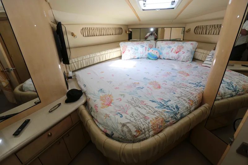 Slide: The Image of Luxurious bedroom interior of 1999 Sea Ray 500 Sundancer yacht with floral bedding. - 15