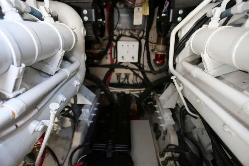 Slide: The Image of Engine room of a 1999 Sea Ray 500 Sundancer, showcasing mechanical components and wiring. - 22