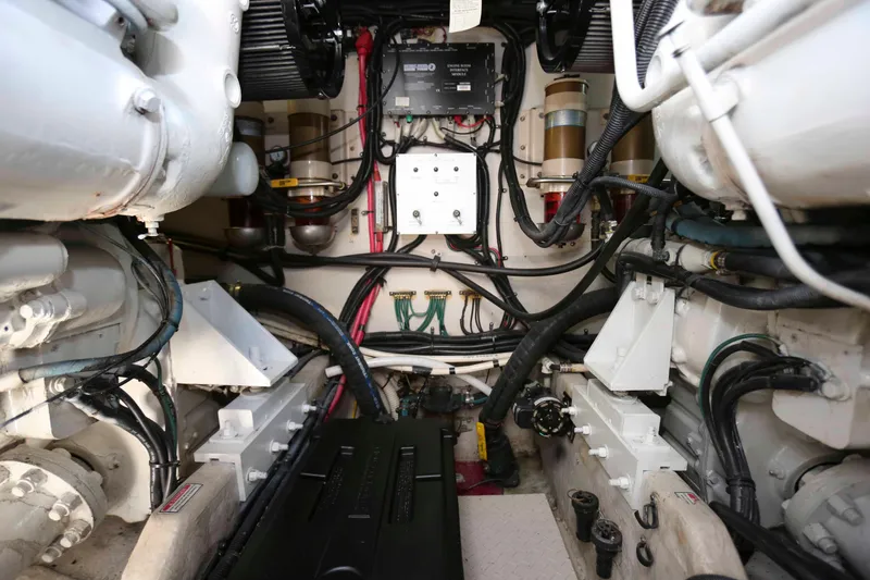 Slide: The Image of Engine room of a 1999 Sea Ray 500 Sundancer with visible machinery and wiring. - 25