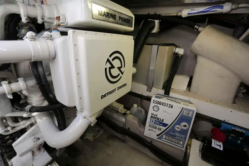 Slide: The Image of Engine room of 1999 Sea Ray 500 Sundancer with Detroit Diesel components and Shell Rotella oil. - 26