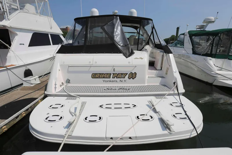Slide: The Image of 1999 Sea Ray 500 Sundancer docked, rear view with "Crime Pay $$" text, Yonkers, N.Y. - 3