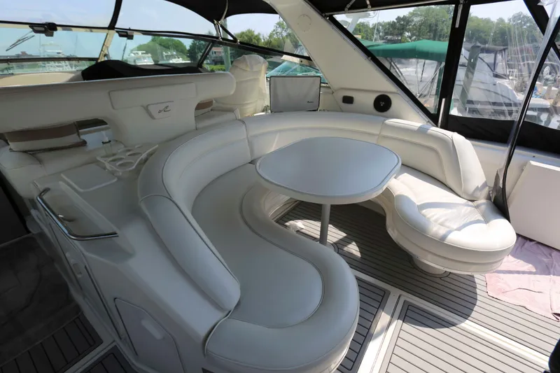 Slide: The Image of Luxurious 1999 Sea Ray 500 Sundancer yacht interior with elegant white seating and table. - 7
