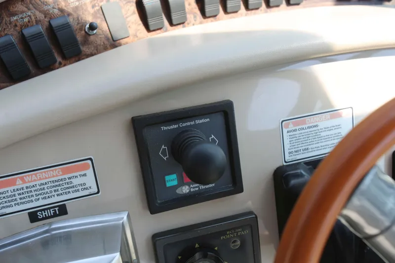 Slide: The Image of Control panel of a 1999 Sea Ray 500 Sundancer boat with thruster controls. - 9