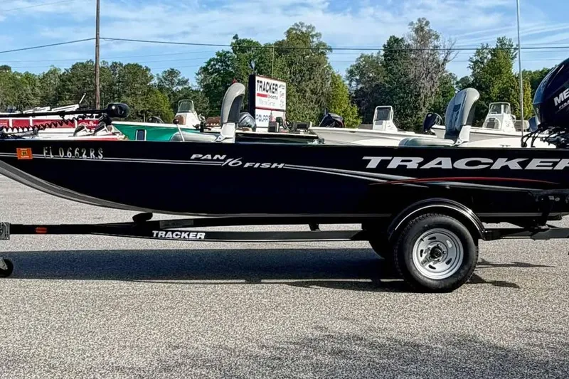 The Image of 2018 Tracker Panfish 16 boat on trailer, parked outdoors with trees in background. - 0