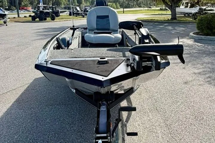 Slide: The Image of 2018 Tracker Panfish 16 boat in parking lot, front view with seating and motor. - 2