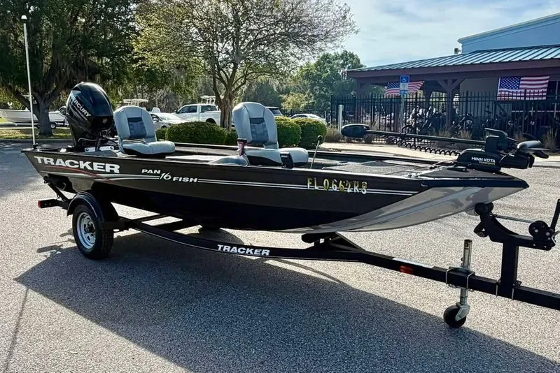 Slide: The Image of 2018 Tracker Panfish 16 boat on trailer, parked outdoors near a building. - 3