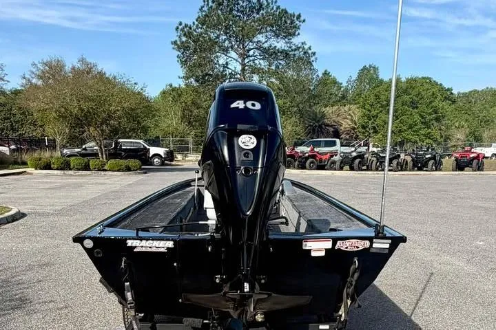 Slide: The Image of 2018 Tracker Panfish 16 boat with 40 HP motor in a parking lot. - 6