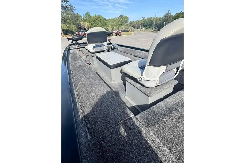 Slide: The Image of 2018 Tracker Panfish 16 boat interior with two seats and carpeted deck. - 8