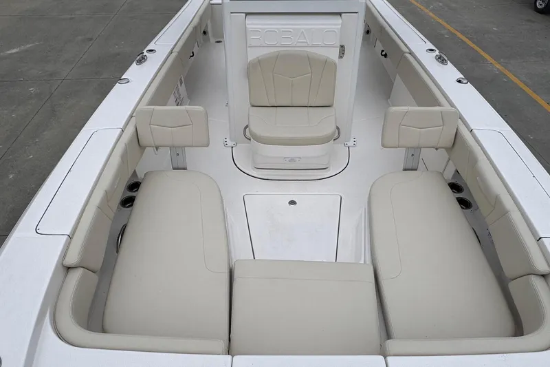 Slide: The Image of 2026 Robalo 266 Cayman boat interior with beige seating and spacious layout. - 10