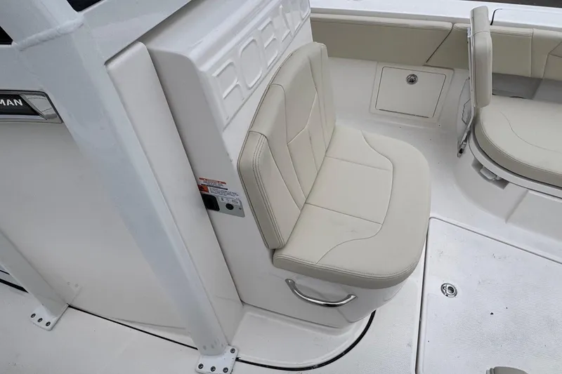 Slide: The Image of 2026 Robalo 266 Cayman boat interior with beige seating and storage compartments. - 11