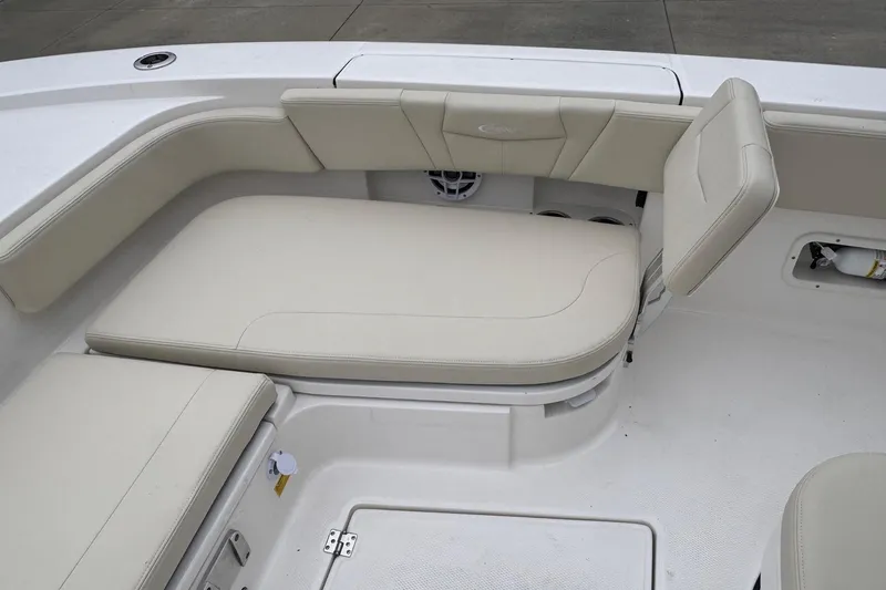 Slide: The Image of 2026 Robalo 266 Cayman boat interior with beige cushioned seating. - 12