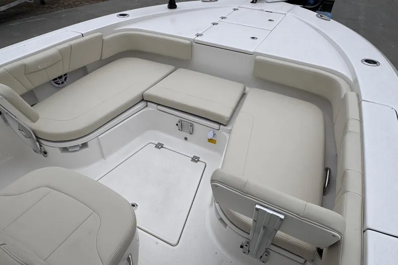 Slide: The Image of 2026 Robalo 266 Cayman boat interior with beige cushioned seating. - 14