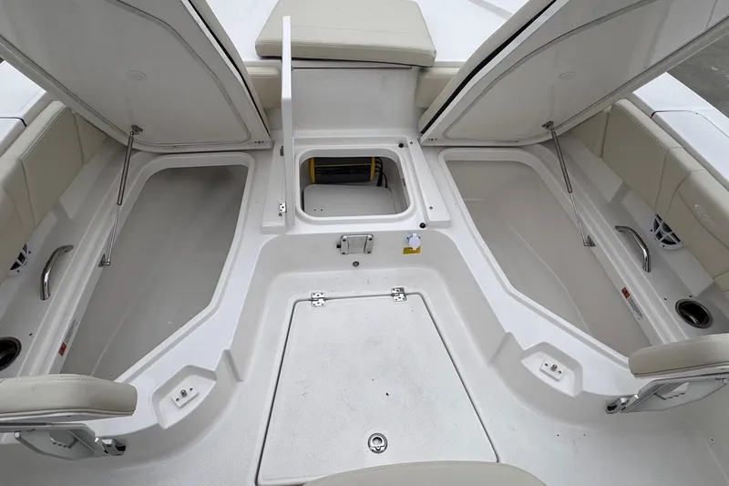 Slide: The Image of 2026 Robalo 266 Cayman boat interior with open storage compartments and seating. - 16