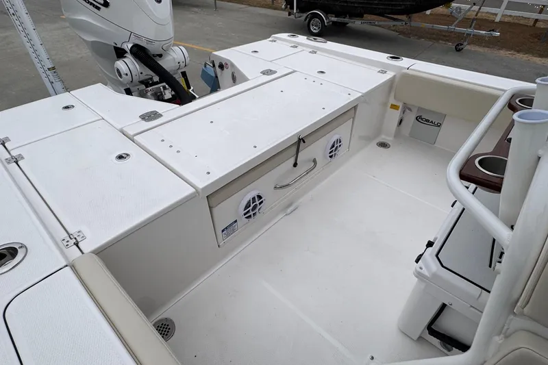 Slide: The Image of 2026 Robalo 266 Cayman boat deck with storage compartments and motor. - 19