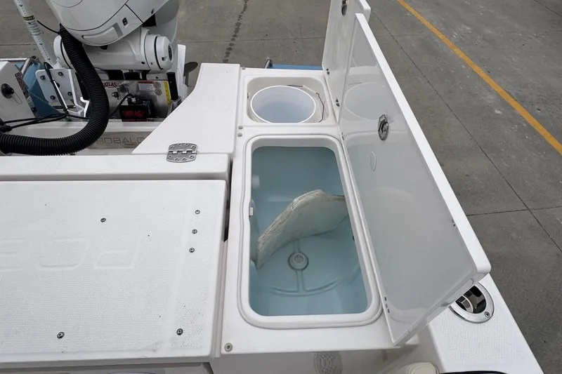 Slide: The Image of Livewell compartment on a 2026 Robalo 266 Cayman boat, open with water inside. - 20