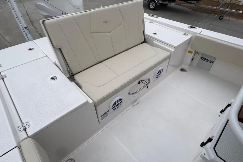 Slide: The Image of 2026 Robalo 266 Cayman boat interior with beige seating and storage compartments. - 23