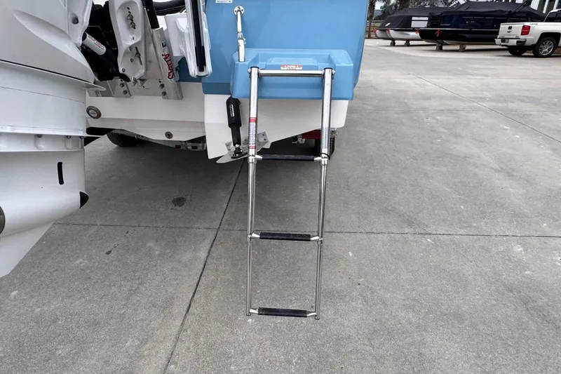 Slide: The Image of Rear view of 2026 Robalo 266 Cayman with extended boarding ladder. - 25