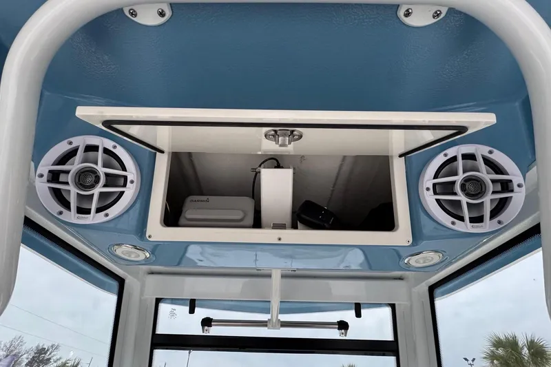 Slide: The Image of 2026 Robalo 266 Cayman boat console with speakers and storage compartment. - 7