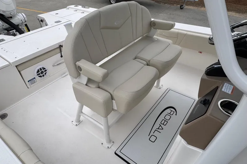 Slide: The Image of 2026 Robalo 266 Cayman boat interior with beige seating and console. - 9