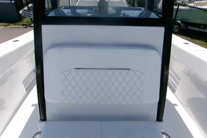 Slide: The Image of 2026 Sportsman Open 252 Center Console boat interior with white cushioned seating. - 17