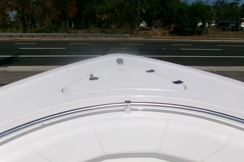 Slide: The Image of 2026 Sportsman Open 252 Center Console boat bow view near a road. - 18